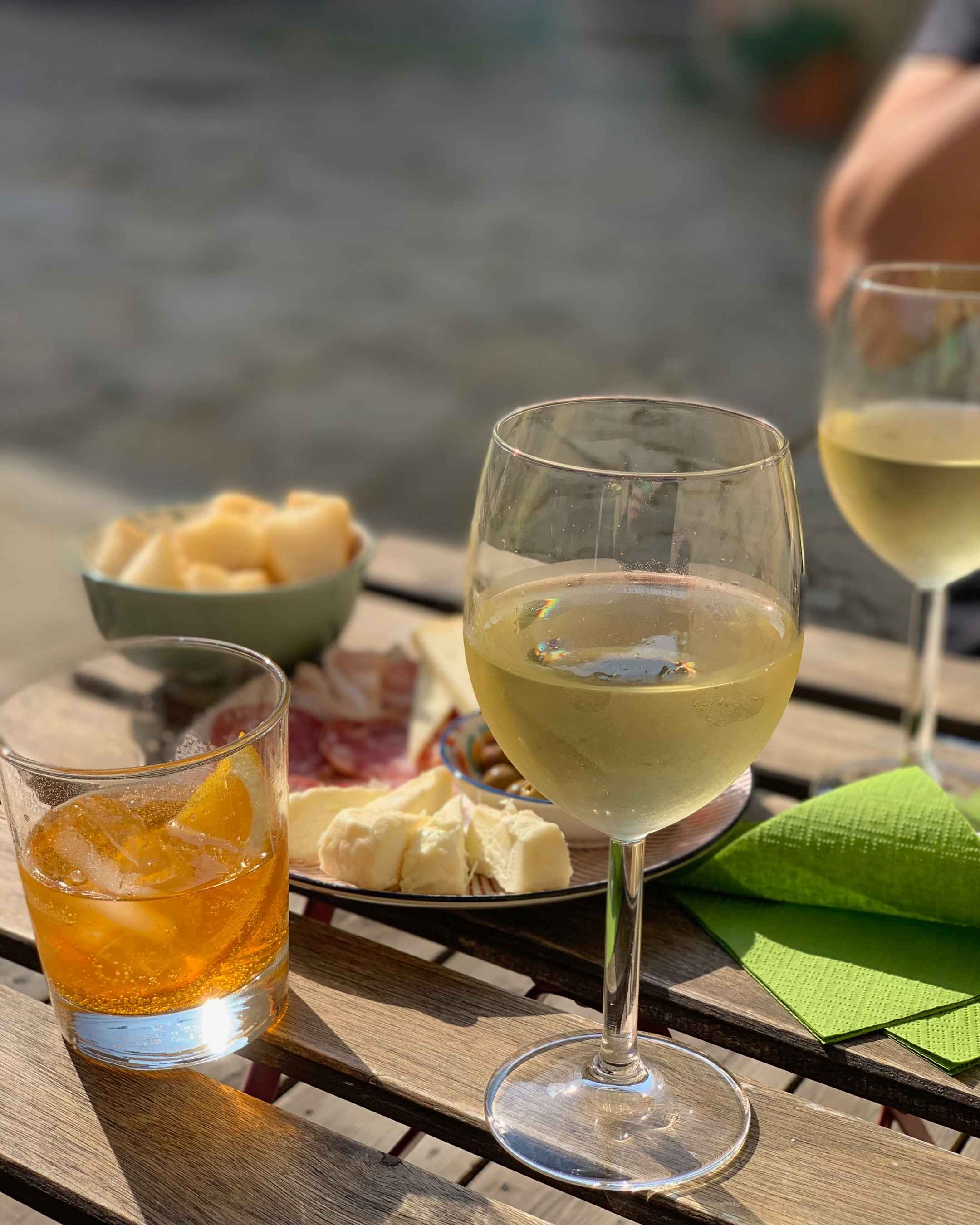 A typical Piedmontese aperitivo with toma cheese, salami, and Favorita wine.