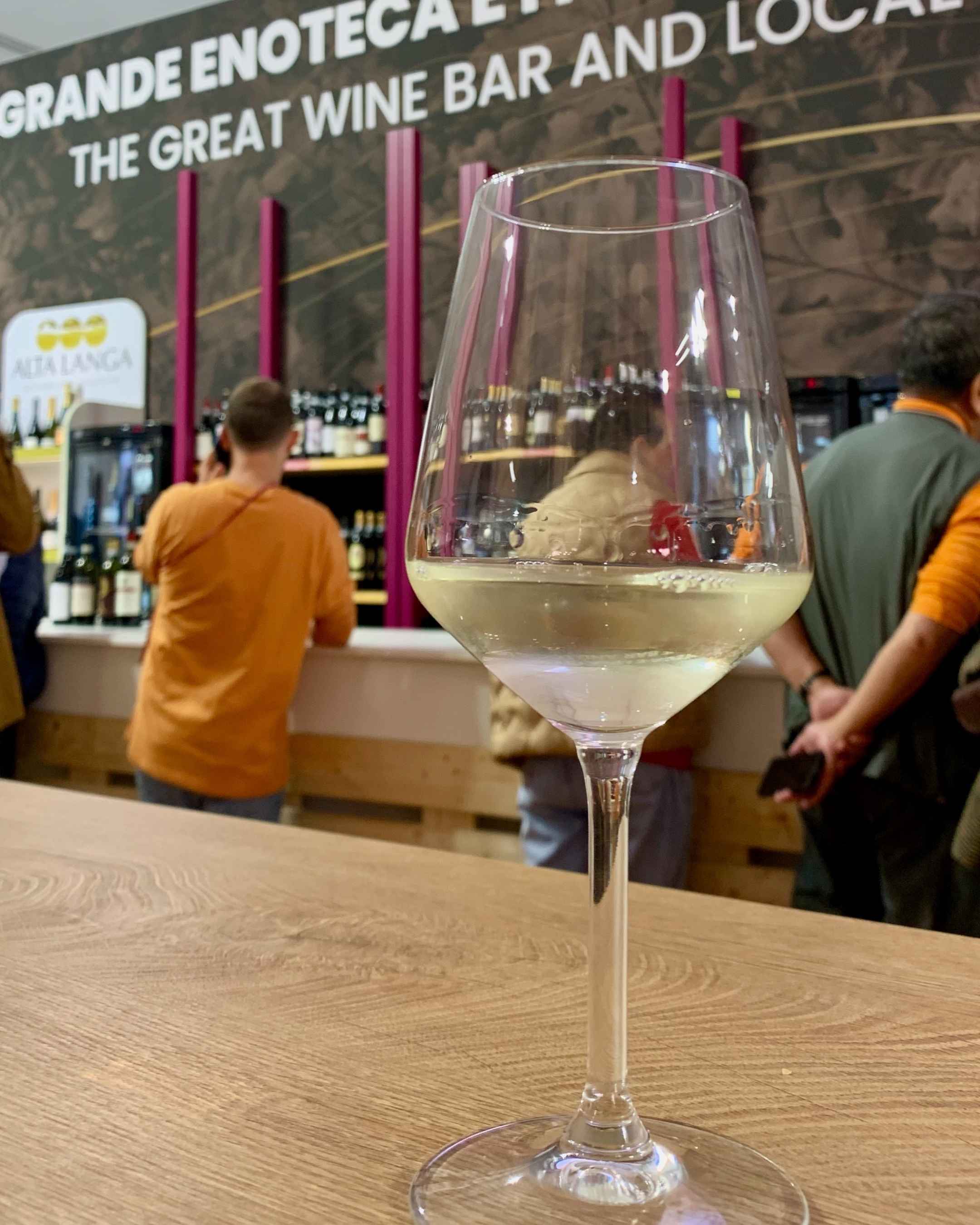 A glass of Favorita white wine at the Alba Truffle Fair