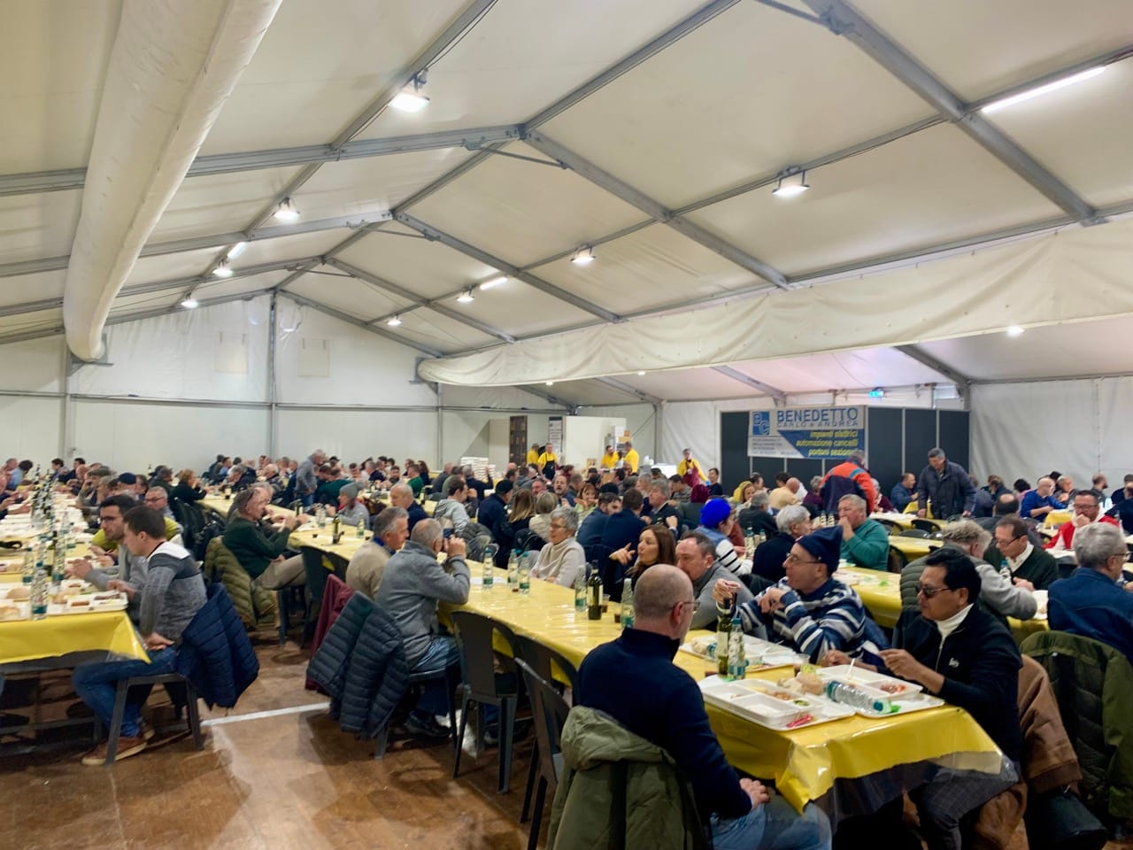 People eating a breakfast of bollito and red wine in Carrù.