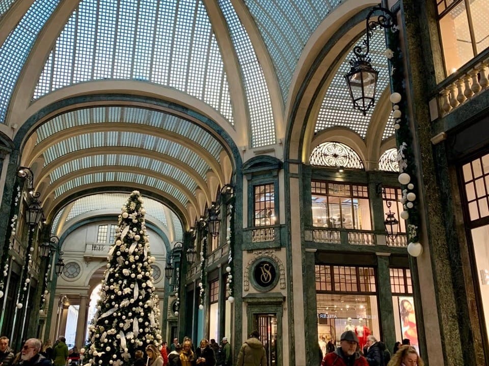 A Christmas tree and decorations inside one of Turin's galleries.